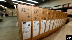 Four pallets of Lenovo Chromebook laptops sit in a Denver Public Schools warehouse after arriving, Friday, Aug. 21, 2020, in Denver.