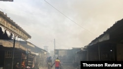 Smoke rises over the neighboring houses after the fire tore through an overcrowded New-Bell central prison in the port city of Douala, Cameroon, on May 28, 2020.