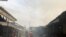Smoke rises over the neighboring houses after the fire tore through an overcrowded New-Bell central prison in the port city of Douala, Cameroon, on May 28, 2020.