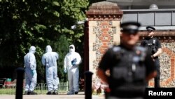 Police officers and forensic officers are pictured near the scene of reported multiple stabbings in Reading, Britain, June 22, 2020. 