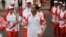 Indonesian President Joko "Jokowi" Widodo, center, holds the Asian Games torch as he runs during an independence day ceremony at Merdeka Palace in Jakarta, Indonesia, Aug. 17, 2018. Jokowi announced Indonesia would bid for the 2032 Olympic Games.