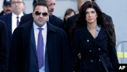 FILE - Giuseppe "Joe" Giudice, left, and his wife, Teresa Giudice, of Montville Township, N.J., walk out of Martin Luther King Jr. Courthouse after a court appearance, in Newark, N.J., Nov. 20, 2013. 