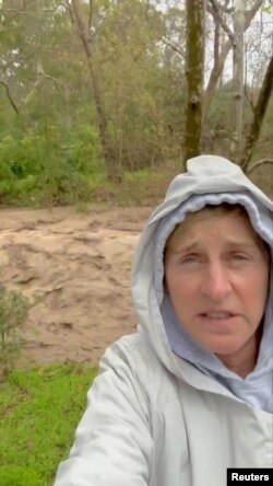 Actress-comedian Ellen DeGeneres, is seen in a video of herself standing besides muddy rapids flowing through what she described as a normally dry creek bed near her property, in Santa Barbara, California, in this screen grab obtained from a social media video released Jan. 9, 2023.