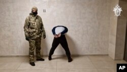 FILE —In this photo taken from video released by Investigative Committee of Russia on March 24, 2024, a suspect stands inside the Russian Investigative Committee headquarters in Moscow, Russia.