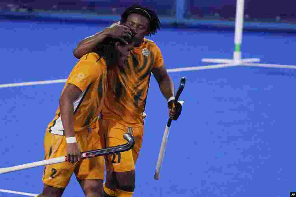 South Africa forward Nqobile Mansuet Ntuli (27) celebrates after South Africa forward Mustaphaa Cassiem (2) scored against the Netherlands during a men&#39;s field hockey match at the 2020 Summer Olympics, Sunday, July 25, 2021, in Tokyo, Japan. (AP Photo/John Locher)