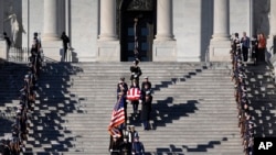 The flag-draped casket of former President Jimmy Carter is carried from the U.S. Capitol on the way to a state funeral at the National Cathedral, in Washington, Jan. 9, 2025. 