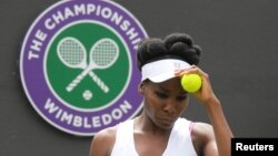 Venus Williams of the United States prepares to serve during her match against Belgium's Elise Mertens on the opening day at the Wimbledon Tennis Championships in London, July 3, 2017.