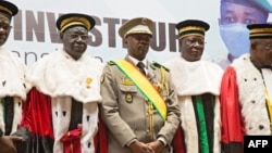 New interim Malian President, Colonel Assimi Goita, center, stands with members of the Supreme Court during his swearing in ceremony in Bamako on June 7, 2021.