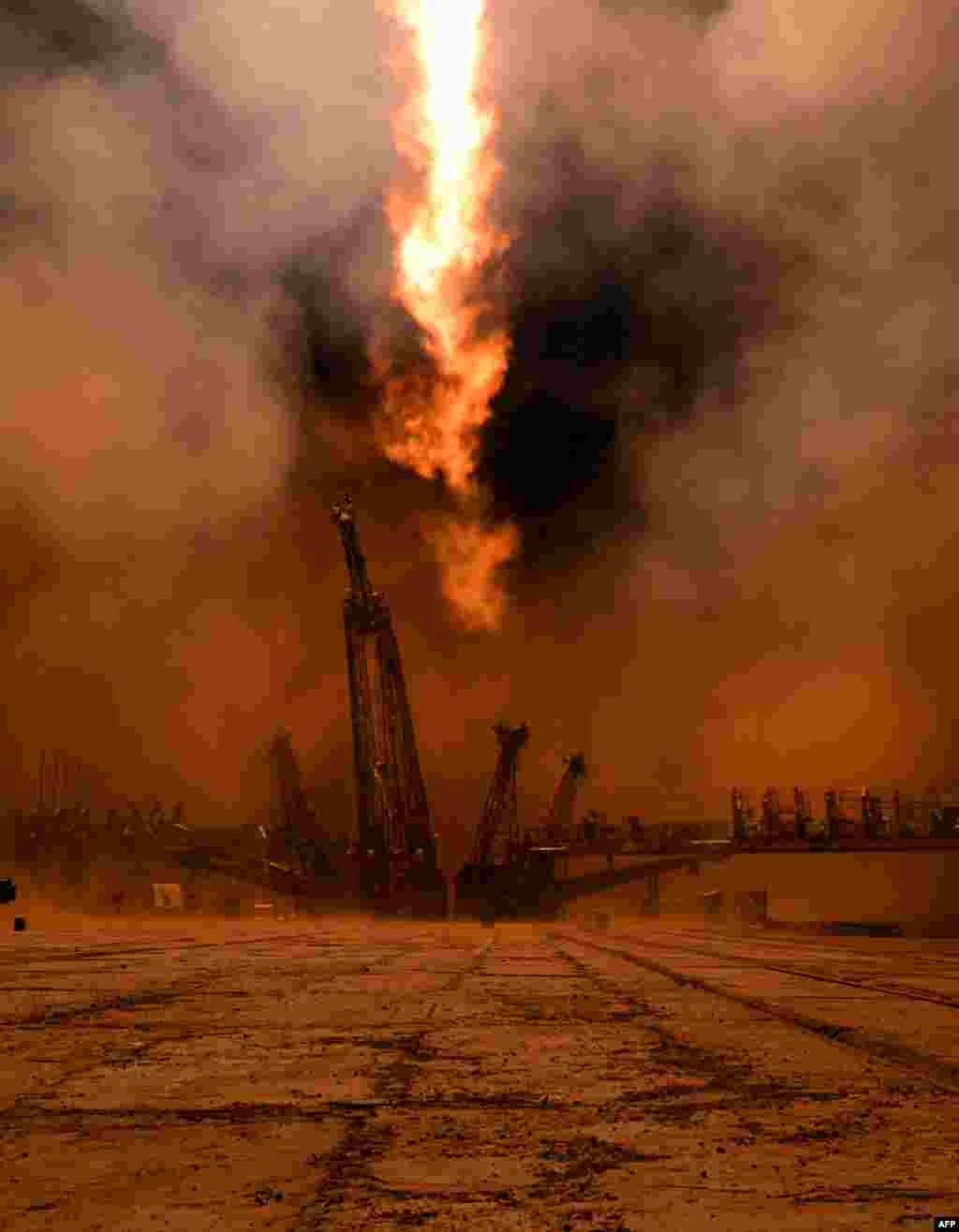 Russian Soyuz-FG rocket with the Soyuz TMA-12M spacecraft and a crew of U.S. astronaut Steven Swanson, Russian cosmonauts Alexander Skvortsov and Oleg Artemyev aboard, blasts off from a launch pad at the Russian-leased Baikonur cosmodrome in Kazakhstan.