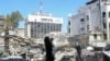 An excavator clears rubble after a suspected Israeli strike on Iran's consulate, in Damascus
