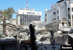 FILE—An excavator clears rubble after a suspected Israeli strike on Iran's consulate, near the main Iranian embassy building, which Iran said had killed seven military personnel including two key figures in the Quds Force, in the Syrian capital Damascus, Syria, April 2, 2024.