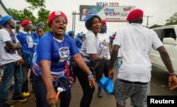 FILE - Ruling party supporters dance as they attend to his final campaign rally for the presidential elections in Monrovia, Liberia October 8, 2023.