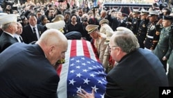 The casket containing Hmong war hero and community leader General Vang Pao is unloaded from a horse drawn carriage at the start of his five day funeral in Fresno, Central California, February 4, 2011