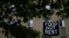 Makeshift banners displaying messages of protest contesting the ability to pay for rent hang in the window of an apartment building in the Columbia Heights neighborhood in Washington, May 18, 2020. 