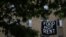 Makeshift banners displaying messages of protest contesting the ability to pay for rent hang in the window of an apartment building in the Columbia Heights neighborhood in Washington, May 18, 2020. 