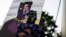Mason Wilkes, 4, of South Carolina poses in a Black Panther costume, in front of a painting, during a Chadwick Boseman Tribute in Anderson, S.C., Sept. 3, 2020.