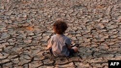 A child remains at an area affected by a drought on Earth Day in the southern outskirts of Tegucigalpa on April 22, 2016.