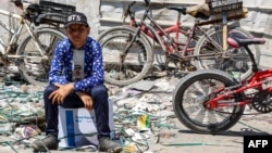 A boy sits atop a humanitarian aid package provided by the United Nations Relief and Works Agency for Palestine Refugees in central Gaza City on Aug. 27, 2024.