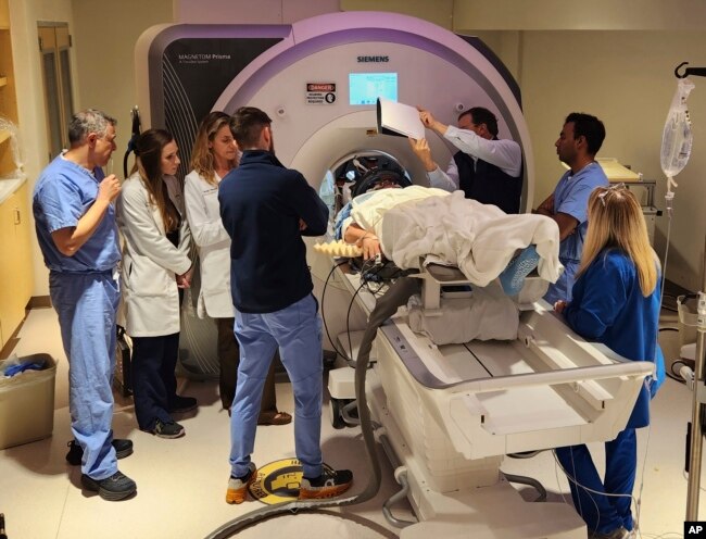 In this photo provided by the WVU Rockefeller Neuroscience Institute, an Alzheimer’s patient undergoes focused ultrasound treatment with the WVU RNI team in Morgantown, W.Va., on Oct. 17, 2023. (Victor Finomore/WVU Rockefeller Neuroscience Institute via AP)