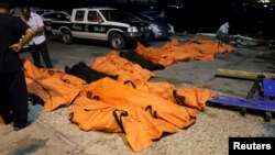 A view of the bodies of dead migrants that were recovered by the Libyan coastguard after a boat sank off the coastal town of Zuwara, west of Tripoli, August 27, 2015.