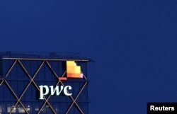 FILE - The logo of accounting firm PricewaterhouseCoopers (PwC) is seen on the top of a Brussels' office of the company in Diegem, Belgium September 21, 2023.