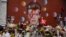 FILE - Tributes lie placed around a mural of British singer David Bowie by artist Jimmy C in Brixton, south London, Thursday, Jan. 14, 2016. 
