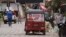 A taxi drives past with a campaign poster on rear window promoting late Mayor Francisco Gaitan, in Cantarranas, Honduras, Nov. 27, 2021.
