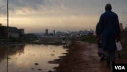 Settlements along drainage pathways often causes flooding and stagnant water along walkways. These large pools of water increase the risk of diseases such as malaria and cholera. (E. Paulat/VOA)