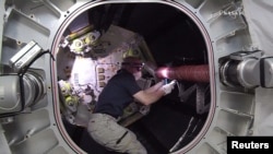 NASA astronaut Jeff Williams works inside the Bigelow Expandable Activity Module (BEAM) attached to the International Space Station in this still image from NASA TV taken June 6, 2016.