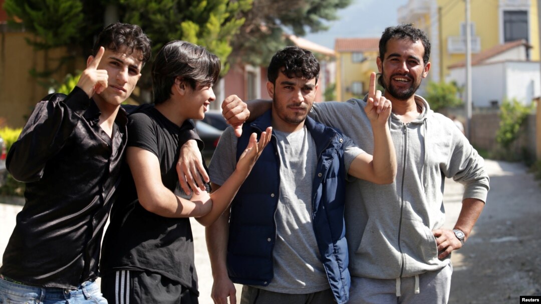 Syrian migrants are pictured in front of the National Reception Center For Asylum Seekers in Tirana, Albania, June 6, 2018. 