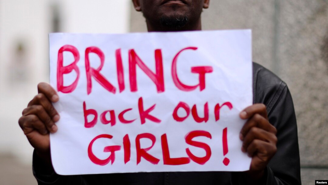 Seorang pria membawa kertas bertuliskan "Kembalikan Anak-anak Perempuan Kami" dalam sebuah aksi di Cape Town, Afrika Selatan, untuk mendukung siswi-siswi yang diculik kelompok militan Boko Haram di Nigeria (8/5).