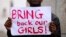 A protester holds a sign during a march in support of the girls kidnapped in Nigeria by members of Boko Haram, in Cape Town, May 8, 2014.