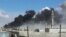 Smoke rises after airstrikes by military jets in Talbiseh, a city in western Syria’s Homs province, where Russia launched airstrikes for the first time, Sept. 30, 2015. The image was made from video provided by Homs Media Center and authenticated by AP. 