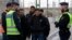 FILE - Swedish police officers speak to a group of people at the Hyllie train station near Malmo, Sweden, Nov. 12, 2015. 