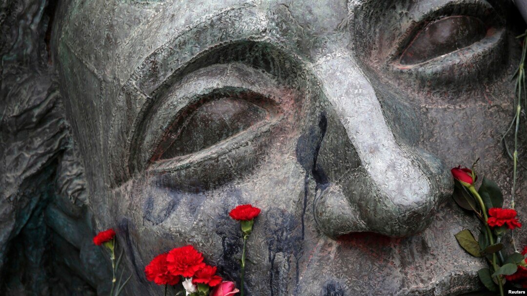 Flowers are placed on a monument inside the Athens' Polytechnic school, on the eve of the 41st anniversary of a 1973 student uprising against the then military ruling junta in Athens, Nov. 16, 2014.