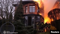 Firefighters work at the site of a Russian missile strike in Dnipro, Ukraine, Nov. 21, 2024. (Press service of the State Emergency Service of Ukraine in Dnipropetrovsk region/Handout via REUTERS)