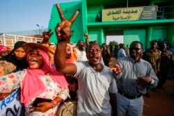 FILE - Sudanese people gather outside al-Huda prison in Khartoum's twin city of Omdurman, July 4, 2019, during a ceremony marking the release of 235 members of a faction of the Sudan Liberation Army, which has fought government forces in Darfur.