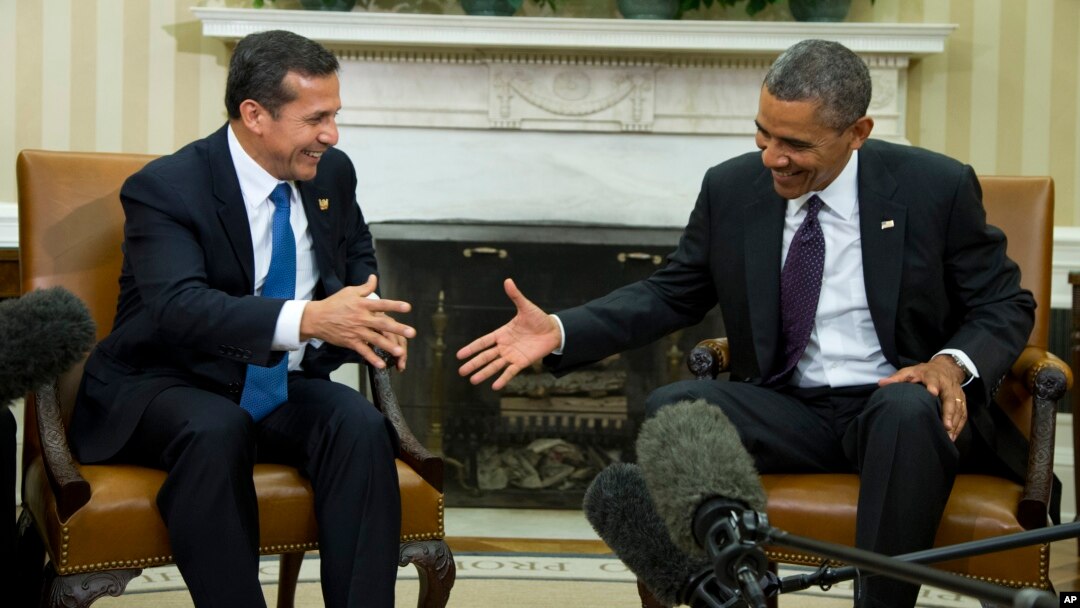 President Barack Obama reaches to shakes hands with with Peru's President Ollanta Humala in the Oval Office of the White House in Washington, June 11, 2013.