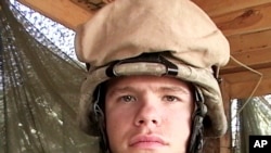 In this April 13 2006, photo, provided by the Lucas family, Marine Lance Cpl. Kevin Adam Lucas poses while serving in Anbar province in Iraq. 