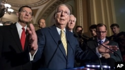 Senate Majority Leader Mitch McConnell, R-Ky., joined by, from left, Sen. John Barrasso, R-Wyo., Sen. John Thune, R-S.D., and Majority Whip John Cornyn, R-Texas, meets with reporters following a closed-door strategy session, at the Capitol in Washington, June 20, 2017.