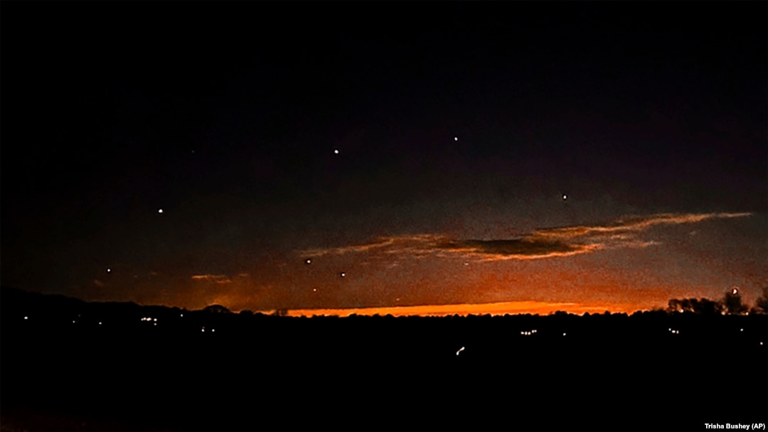 FILE - This photo provided by Trisha Bushey shows the evening sky and points of light near in Lebanon Township, New Jersey, Dec. 5, 2024.