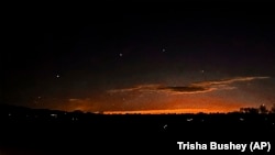 FILE - This photo provided by Trisha Bushey shows the evening sky and points of light near in Lebanon Township, New Jersey, Dec. 5, 2024.