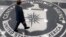 FILE - A man crosses the Central Intelligence Agency (CIA) logo in the lobby of CIA Headquarters in Langley, Virginia.