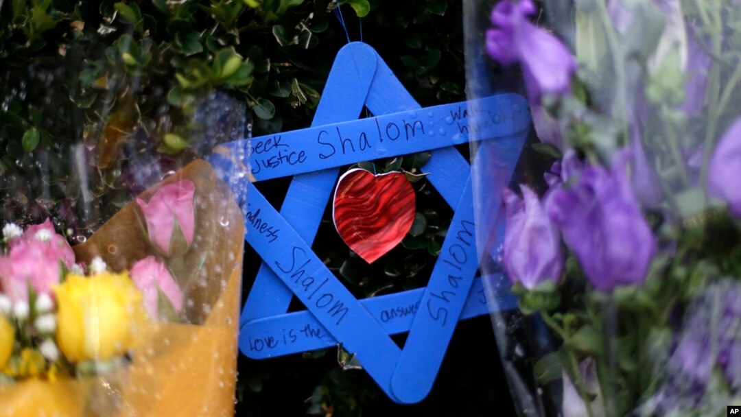 FILE - A Star of David fashioned from ice pop sticks hangs from bushes outside the Tree of Life Synagogue in Pittsburgh, Nov. 20, 2018. 