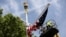 Workers hang a U.S. flag on The Mall towards Buckingham Palace in central London ahead of U.S. President Donald Trump state visit to Britain, June 2, 2019.