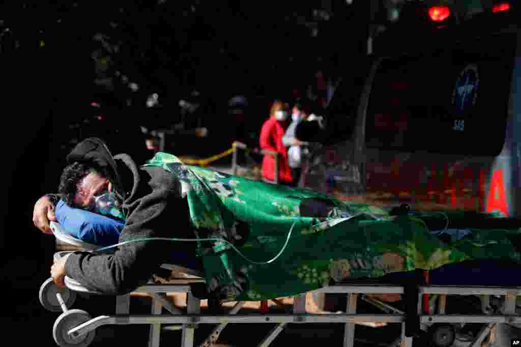 COVID-19 patient Eustaquio Ruiz, 46, lies on a stretcher outside the ICU of the Ineram Hospital, the fourth clinic where he was taken in search of a hospital with room in Asuncion, Paraguay.