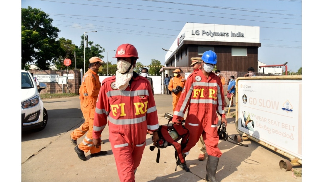 Firefighters walk with oxygen cylinders outside LG Polymers plant, the site of a chemical gas leak, in Visakhapatnam, India, May 7, 2020. Synthetic chemical styrene leaked from the industrial plant in southern India.