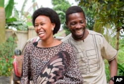 FILE - Uganda's leading opposition challenger Bobi Wine, right, and his wife Barbie Kyagulanyi, cast their votes in Kampala, Uganda, January 14, 2021.