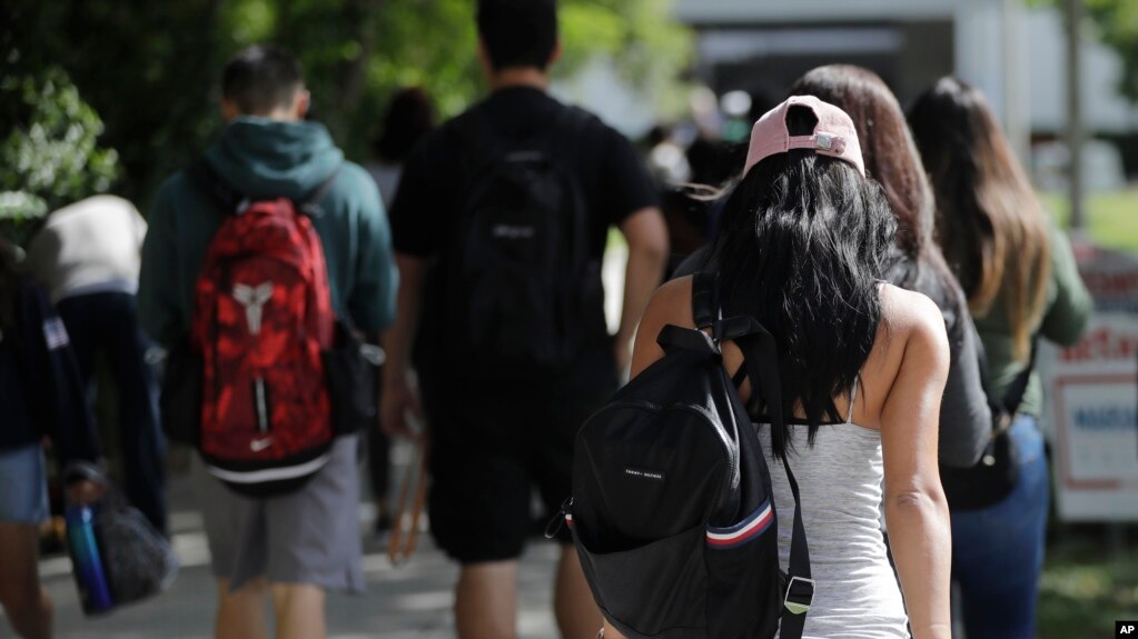FILE - Students walk on the campus of Miami Dade College, in Miami, Oct. 23, 2018. New research shows paying for college tuition is a top worry for U.S. adults, and multiple financial concerns may contribute to psychological distress.