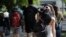 FILE - Students walk on the campus of Miami Dade College, in Miami, Oct. 23, 2018. New research shows paying for college tuition is a top worry for U.S. adults, and multiple financial concerns may contribute to psychological distress.